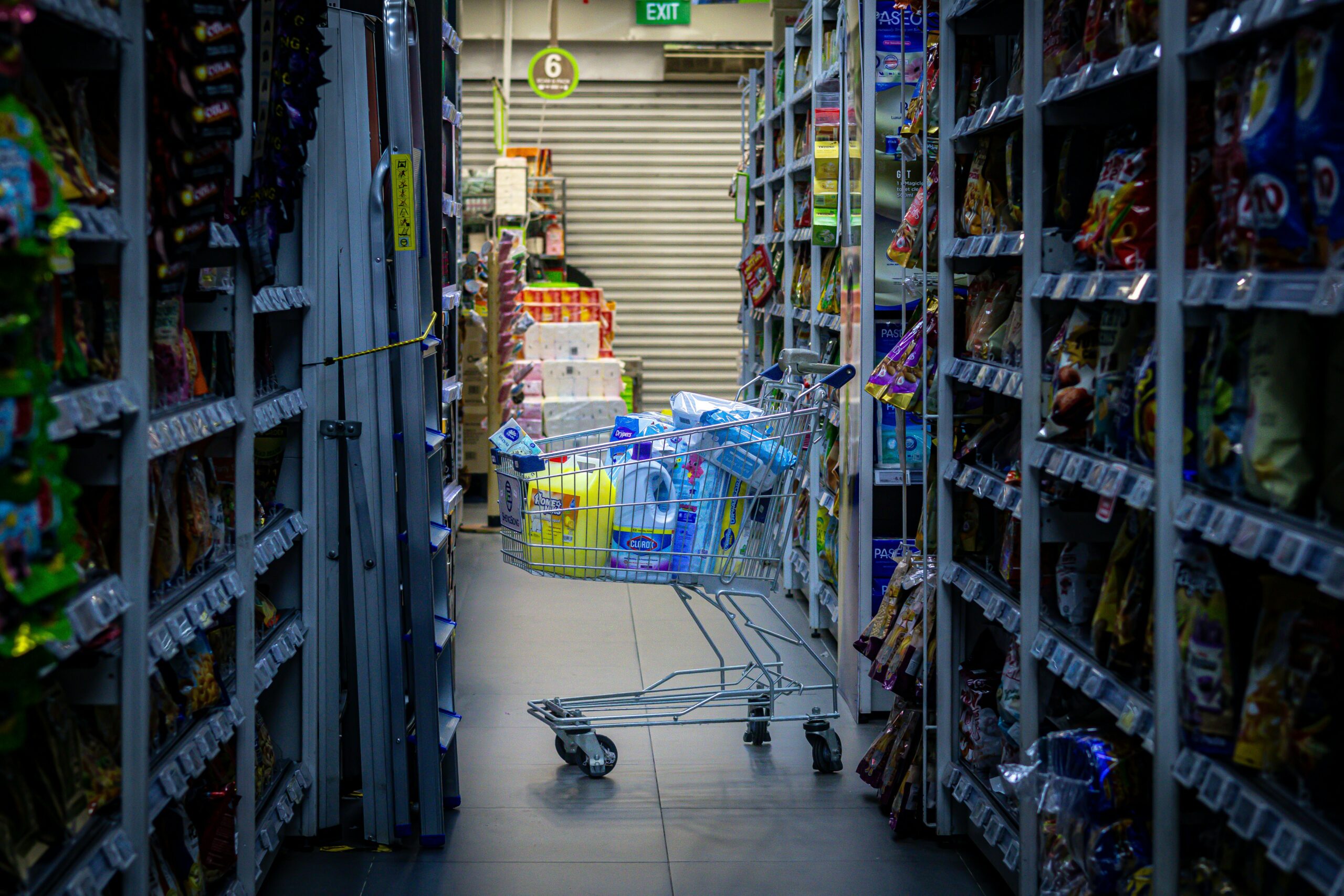 shopping cart abandoned in a grocery store aisle